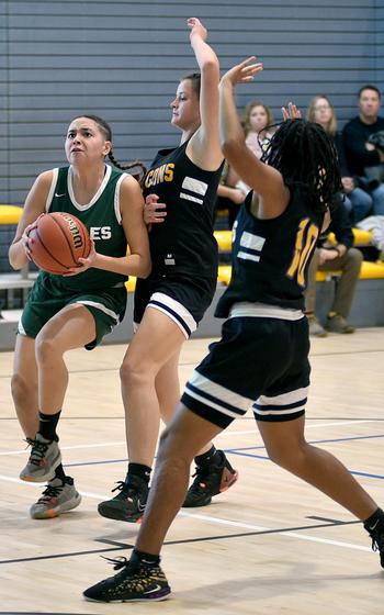 Naples' JuJu Martinez goes up for layup while Bahrain's Brooklyn Barrett, center left, and Dalisa Lewis defend during pool play of the Division II DODEA European Basketball Championships at the Southside Fitness Center on Ramstein Air Base, Germany. 