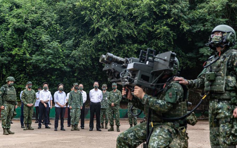 Taiwan President Tsai Ing-wen and other officials watch Taiwanese soldiers demonstrate a weapons system at a military base in Penghu, Aug. 30, 2022.