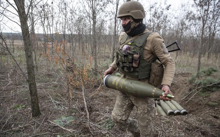 The soldier moves shells as his unit prepares to fire an M777 howitzer at the Russian armored vehicles.