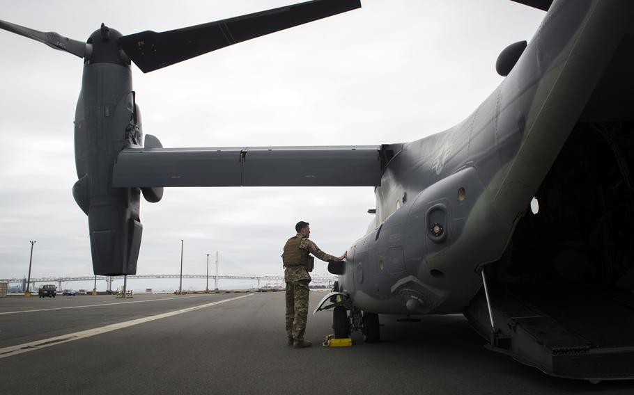 An airman inspects a CV-22 Osprey tiltrotor aircraft at Yokohama North Dock, Japan, April 5, 2018. 