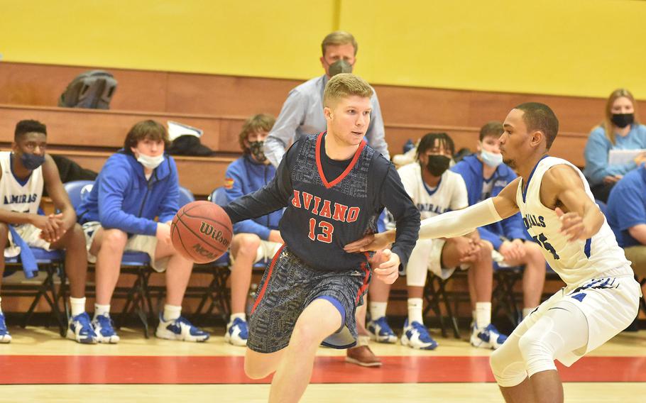 Aviano's Aidan Haas drives toward the basket while guarded by Rota's Emory Butler during the opening day of the DODEA-Europe Division II basketball championships in Vicenza, Italy, on Thursday, March 3, 2022.