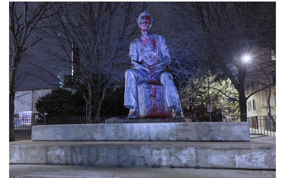 The Young Lincoln statue in Chicago’s Senn Park is covered in red paint with the words “COLONIZER” and “LAND BACK!” written underneath as seen on Thursday, Nov. 24, 2022.