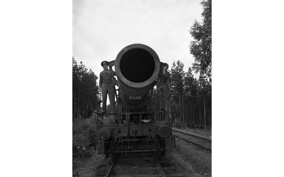 Two unidentified American soldiers flank the massive Nazi Germany-produced railway gun in the woods near Grafenwöhr, Germany, July 1949. The story goes that during a 1943 demonstration of the gun to Hitler himself, German steel and armament producer Krupp’s head of arms fabrication Erich Mueller noted that the gun could also shoot at a Panzer tank, to which Gen. Heinz Guderian, who led the 2nd Panzer Group at the time responded, “Shoot yes, but hit, never!” The devastation caused by the 7-ton shells at Sevastapol however, whether it was a hit or a miss, was reported to be enormous.