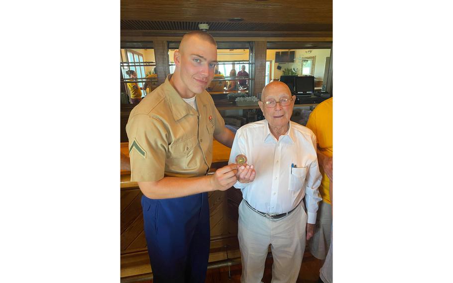 Pfc. Cedar Ross, left, exchanged a challenge coin with his great-grandfather, retired Marine Hershel ‘‘Woody’‘ Williams, right, after Ross graduated from Marine Corps boot camp, June 18, 2021, in Parris Island, S.C. The coins were made by Ross’s uncle, Brent Casey. Casey’s company, Valor Coins and Pins, puts a portion of its proceeds toward the Woody Williams Foundation, which honors Gold Star families.
