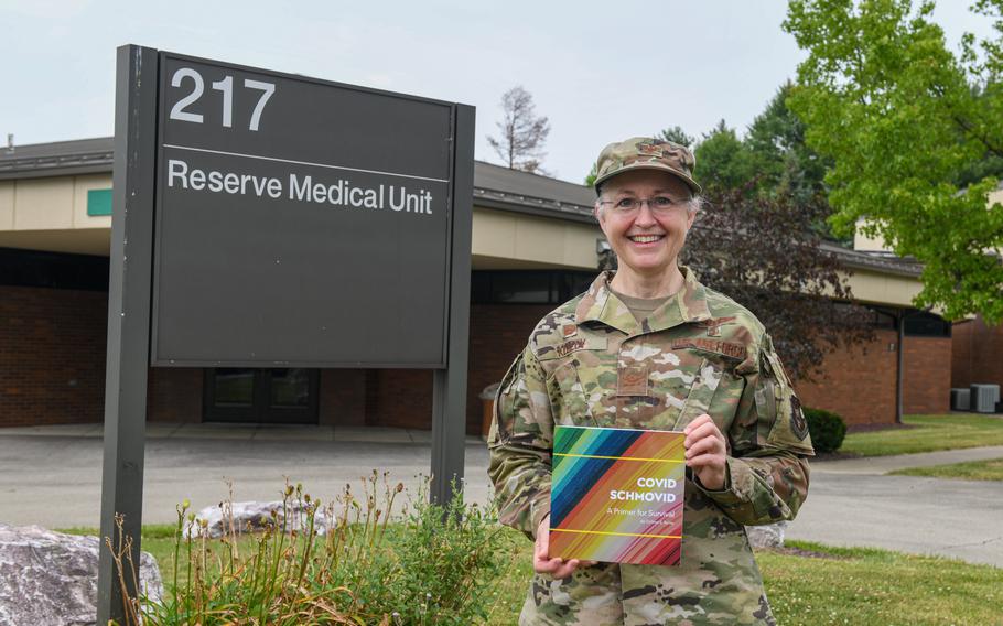 U.S. Air Force Col. Colleen Kelley, the commander of the 910th Medical Squadron in Youngstown, Ohio, shows off her book “COVID SCHMOVID: A Primer for Survival.” Kelley wrote the book as a light-hearted approach on how to stay healthy during the pandemic.