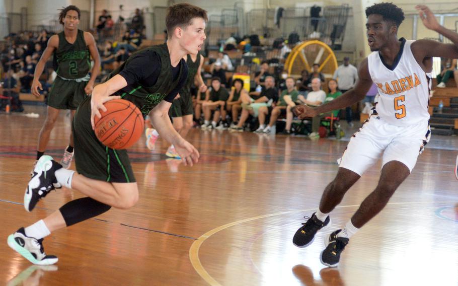 Kubasaki's Lucas Andrews drives against Kadena's Cedrick Dorelien during Sunday's semifinal, which the Panthers won 56-35.