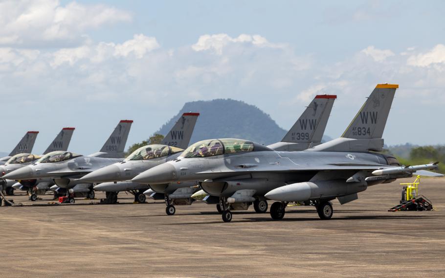 U.S. Air Force F-16 Fighting Falcons pilots conduct pre-flight checks.
