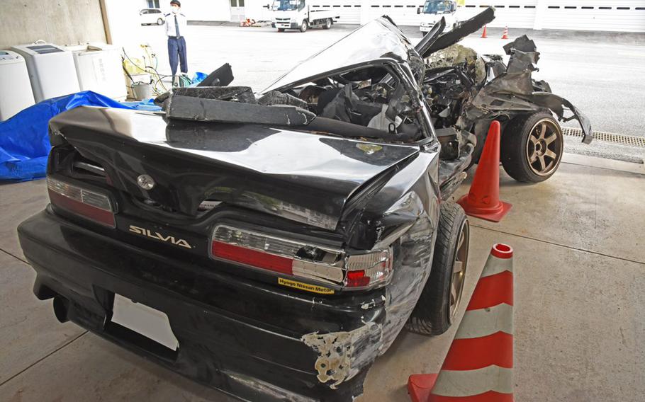 The wreckage of a Marine corporal’s Nissan Silvia is seen at a police garage in Urasoe City, Okinawa, Monday, Feb. 7, 2022.