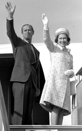 Prince Philip and Queen Elizabeth II wave as they board the plane for the trip home from Tokyo May 12, 1975.