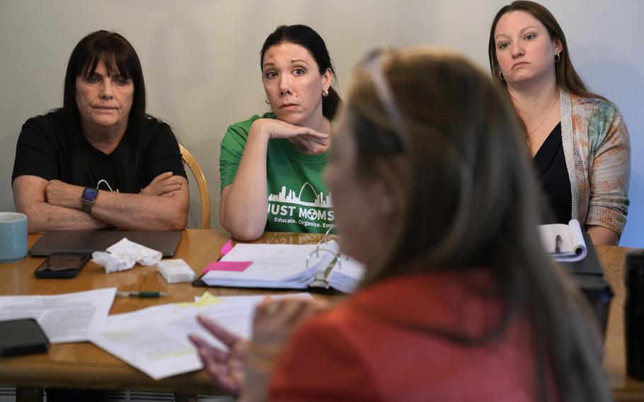 Co-founders of Just Moms STL, Karen Nickel, left, and Dawn Chapman listen along with Ashley Bernaugh, right, as Missouri Rep. Tricia Byrnes, foreground, discusses nuclear contamination in and around the St. Louis area Friday, April 7, 2023, in Maryland Heights, Mo. 