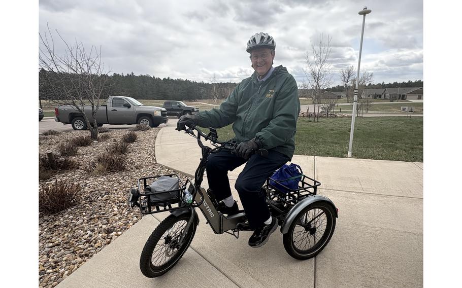 An elderly man on an e-tricycle
