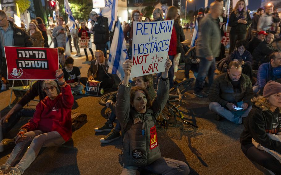 People block the entrance to Israel’s defense ministry headquarters.