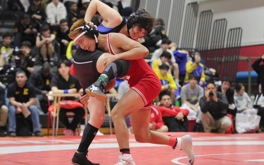 Nile C. Kinnick's Gavin Caddali lifts Zama's Ann-Marie Steele Flores at 114 pounds.