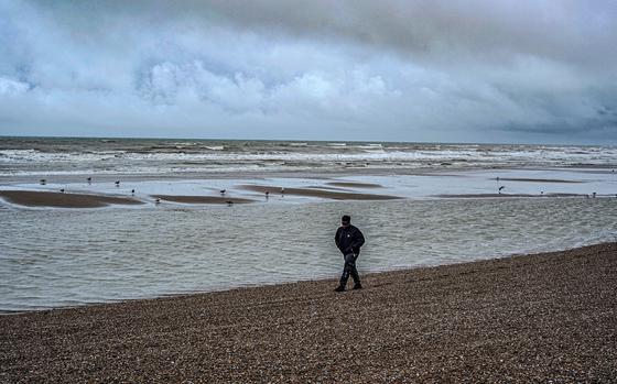 Bidias, a 32-year-old asylum seeker from Cameroon, walks along the beach in Hastings. MUST CREDIT: Photo for The Washington Post by James Forde