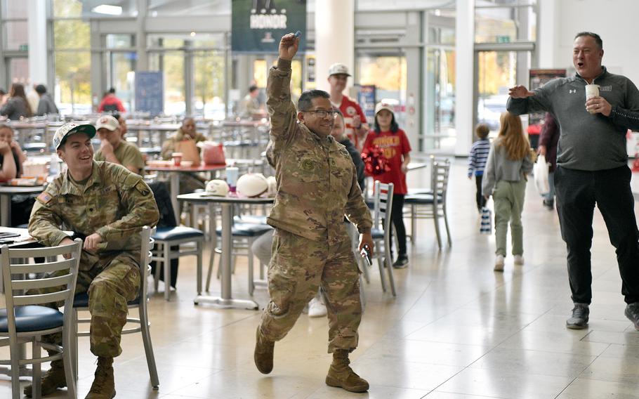 Staff Sgt. Hector Hernandez of the 66th Transportation Company holds up the winning raffle ticket during an event with the Kansas City Chiefs on Nov. 2, 2023, at Ramstein Air Base, Germany. Hernandez received two tickets to the Chiefs' game against the Miami Dolphins on Nov. 5 in Frankfurt.