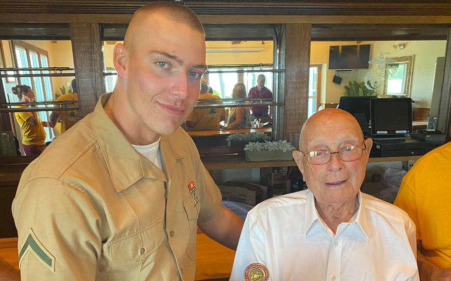 Pfc. Cedar Ross, left, exchanged a challenge coin with his great-grandfather, retired Marine Hershel ''Woody'' Williams, right, the last living recipient of the Medal of Honor from World War II, after Ross graduated from Marine Corps boot camp Friday, June 18, 2021, in Parris Island, S.C. 