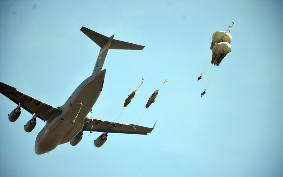 U.S. and Thai paratroopers jump from an Air Force C-17 Globemaster, March 5, 2024, during Cobra Gold training in central Thailand.