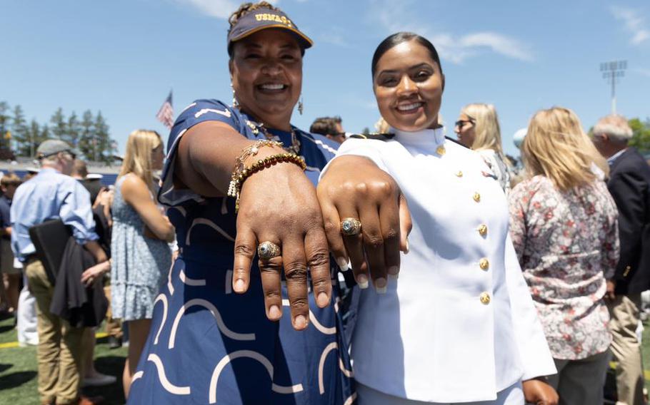 Timika and Elise Lindsay pose with their class rings May 26, 2023, in Annapolis, Md., at the U.S. Naval Academy graduation. They are the first mother-daughter duo to graduate from the academy since its inception in 1845.