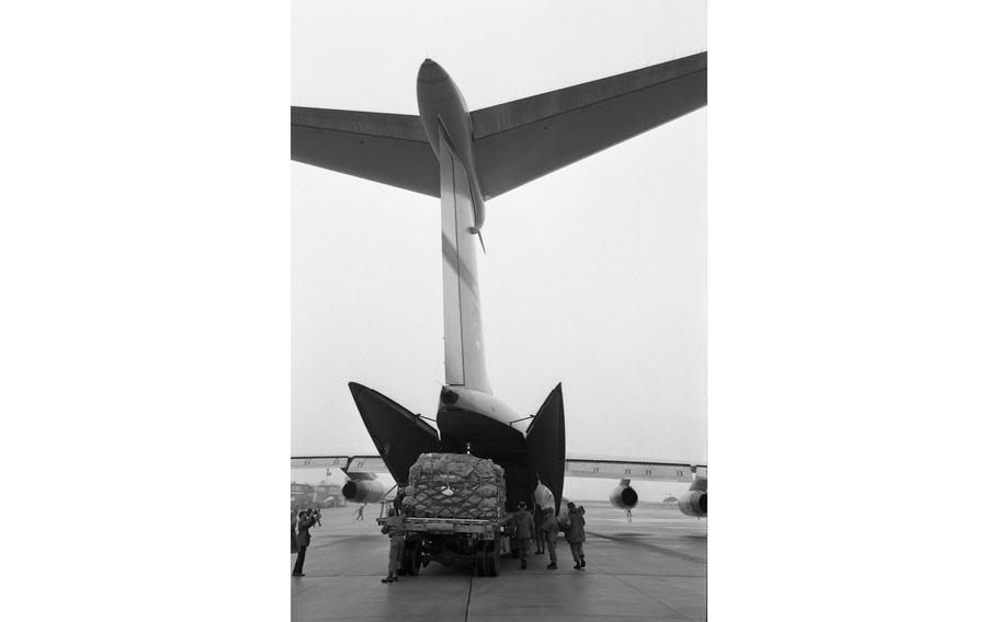 Cargo is offloaded off of the C141 StarLifter of the Military Airlift Command needed for the Reforger I/ Carbide Ice dual Air Force/Army exercise. 