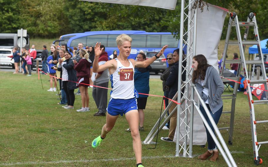 Wiesbaden runner and race winner Luke Jones crosses the finish line of the boys 5-kilometer race at Vilseck, Germany, Saturday, Sept. 10, 2022.Jones finished the race with a time of 16 minutes, 36.12 seconds.