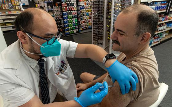Pharmacist Aaron Sun administers a COVID-19 vaccine to Jimmy Smagula at a CVS in Eagle Rock, Calif., in September 2023.