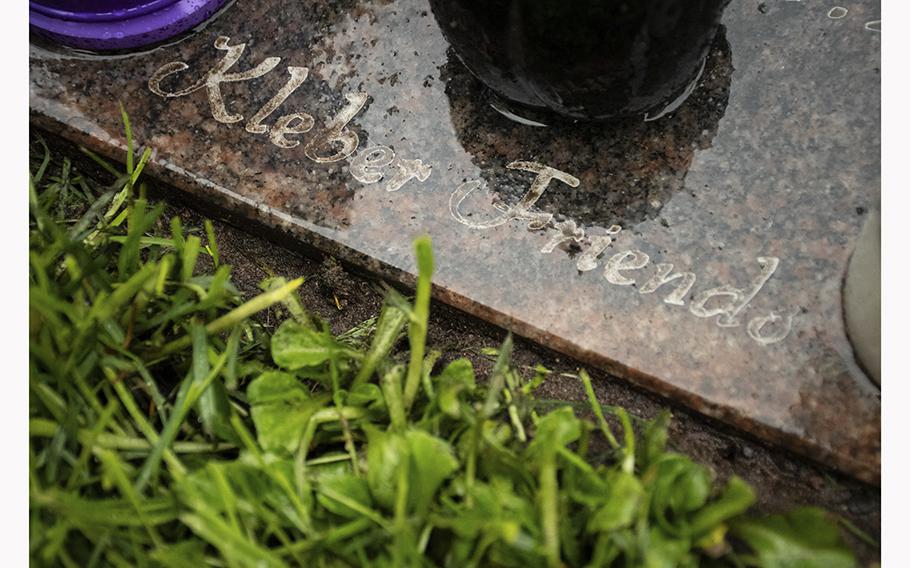 A light rain falls on Ronny Coleman’s gravestone, paid for with donations from the military community on Kleber Kaserne in Kaiserslautern, Germany, on Friday, April 28, 2023. The words “Kleber Friends” are engraved on it. 