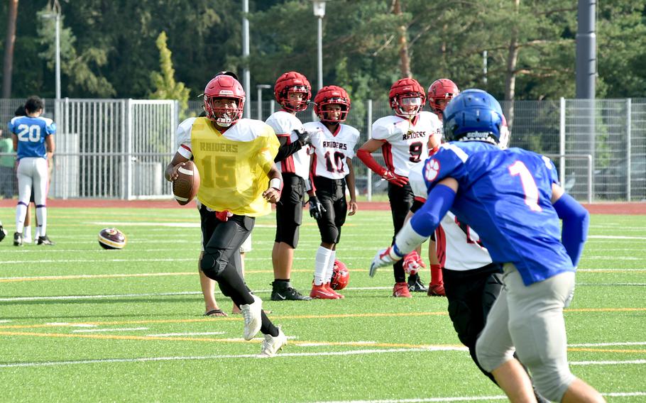Kaiserslautern quarterback Rueben Todman scrambles and looks downfield for a passing option during a scrimmage against the Royal at Ramstein High School on Ramstein Air Base, Germany, on Aug. 25, 2023.
