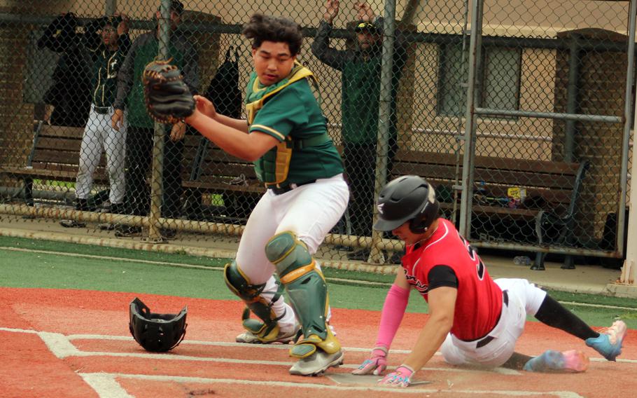 E.J. King's Tom Irby slides in safe past Robert D. Edgren catcher Jayse Ulechong during Monday's Division II basetball tournament game. The Cobras tied Zama 0-0 and beat the Eagles 8-1.