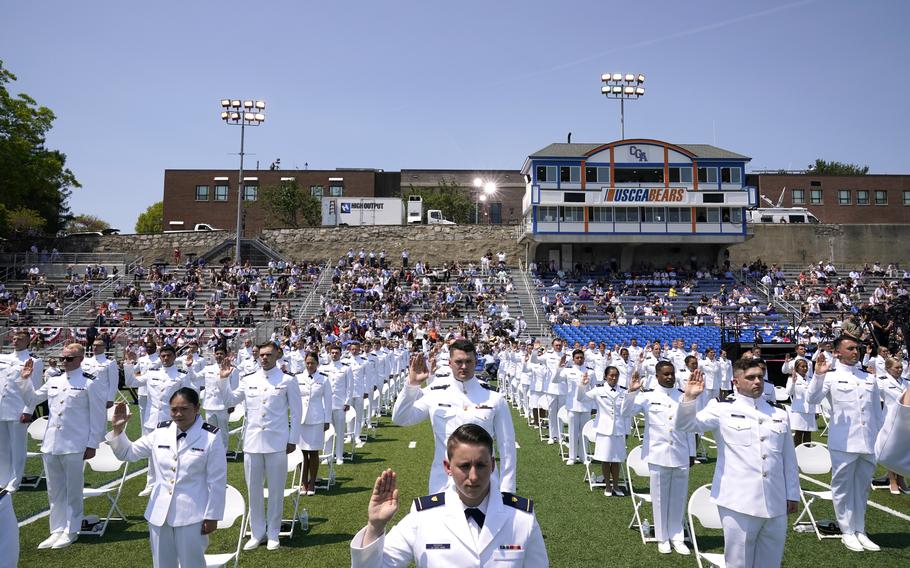 Cadets stand during the commencement for the United States Coast Guard Academy in New London, Conn., Wednesday, May 19, 2021. 