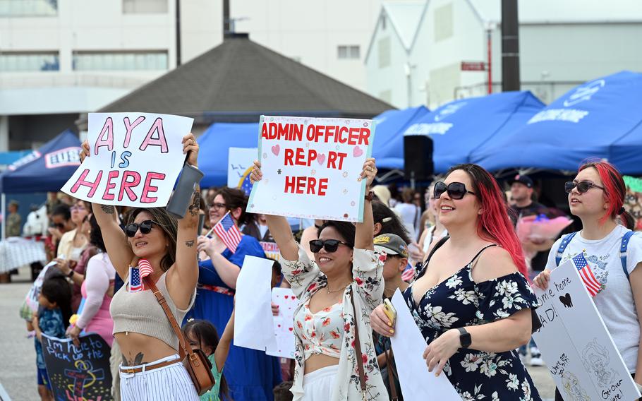 Friends and family of USS Blue Ridge sailors crowd the pier as the amphibious command ship returns.