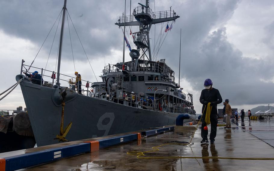 Dock workers at Ishigaki Port, Japan, assist U.S. Navy sailors with the mine countermeasure ship USS Pioneer after the ship arrived on Sept. 7, 2023. 