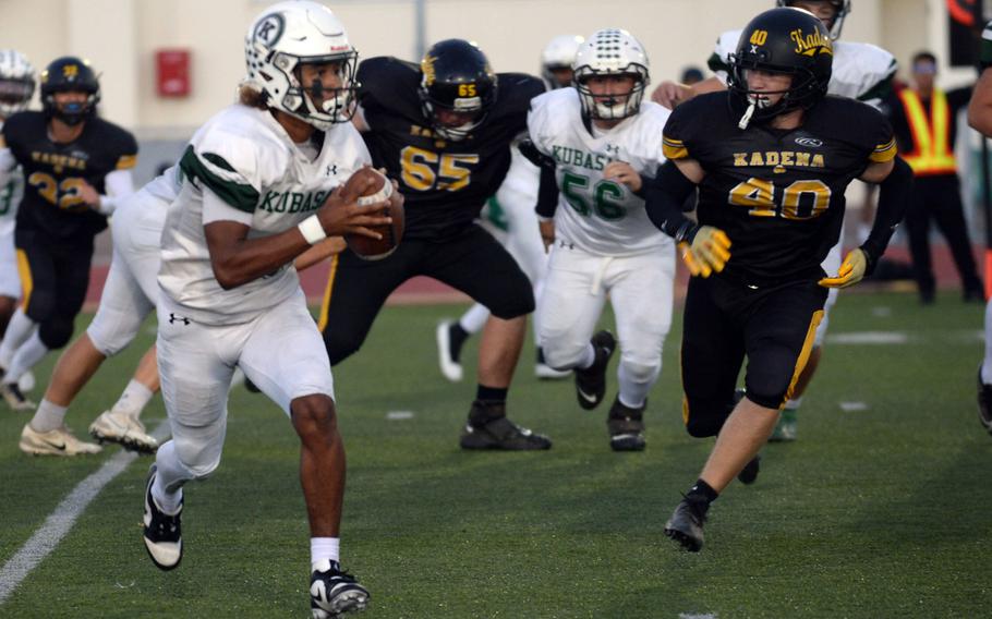 Kubasaki quarterback Trajon Weaver looks for operating room against Kadena's Jackson Stroud.