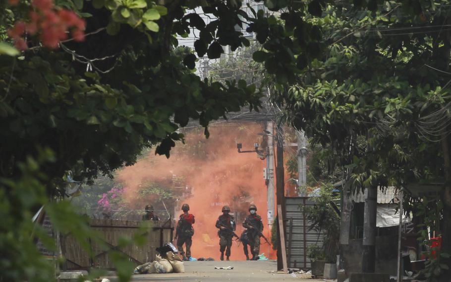 Soldiers walk towards anti-coup protesters during a demonstration in Yangon, Myanmar on March 30, 2021. According to reports on Thursday, Sept. 23, 2021, a town in Myanmar’s western Chin state was abandoned as government troops and a local resistance group battled each other.