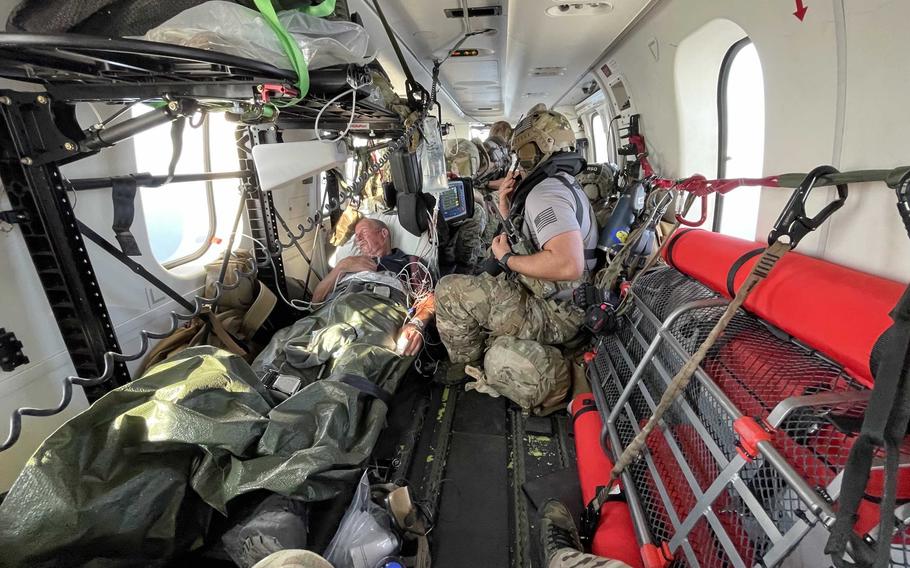 U.S. Air Force pararescuemen assigned to Combined Joint Task Force - Horn of Africa Personnel Recovery Task Force treat UK merchant mariner Kevin Nixon on board a DHC-8 airplane during a complex two-day medical evacuation from the Indian Ocean.