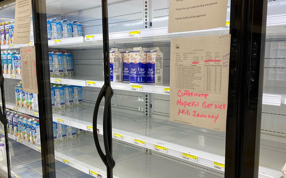 A dairy case at Yokota Air Base in western Tokyo sits mostly empty on Thursday, Jan. 13, 2022. 