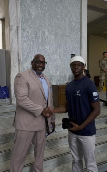 Two people shaking hands on Capitol Hill.