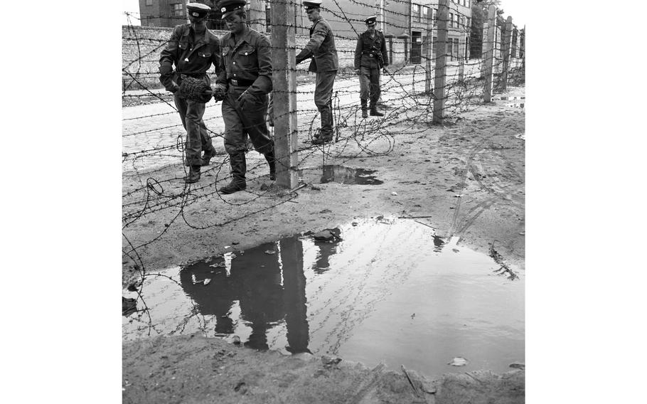 Barbed wire plays an important part in the East Zone Communists’ scheme of things, as demonstrated by those Vops who are laying a strand at the border in Berlin.