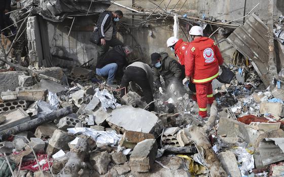 Paramedic workers search for victims in the rubble of a paramedic center that was destroyed by an Israeli airstrike early Wednesday in Hebbariye village, south Lebanon, Wednesday, March 27, 2024. The Israeli airstrike on a paramedic center linked to a Lebanese Sunni Muslim group killed several people of its members. The strike was one of the deadliest single attacks since violence erupted along the Lebanon-Israel border more than five months ago. (AP Photo/Mohammed Zaatari)