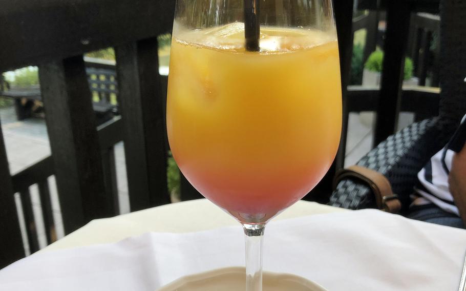 An alcohol-free cocktail to start out the evening, made with apple and orange juice, pomegranate syrup and infused with bitter lemon, at the Forsthaus Rheinblick in Wiesbaden, Germany.