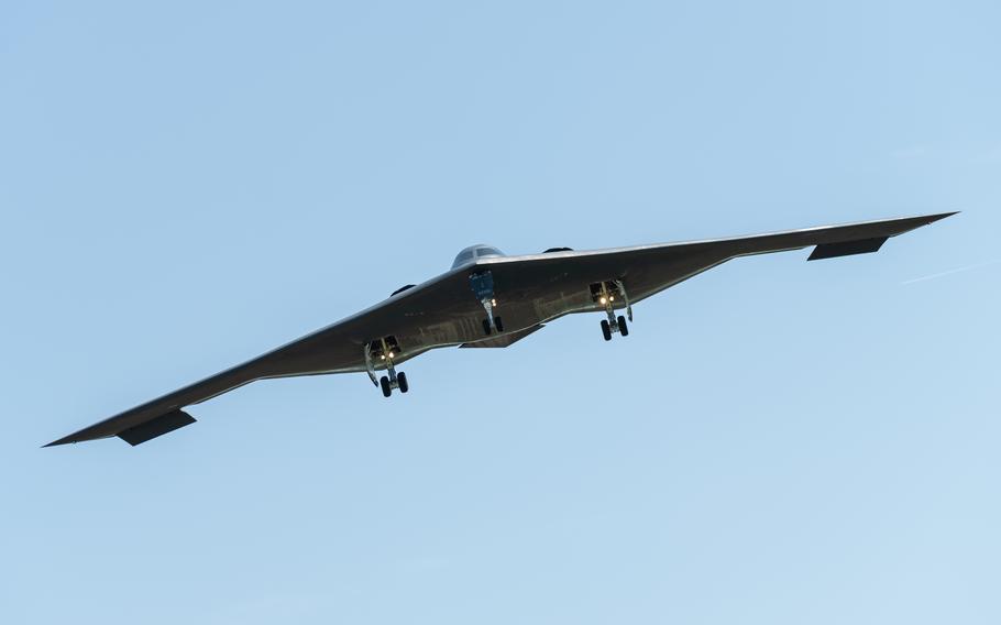 A B-2 Spirit stealth bomber flies through the sky.