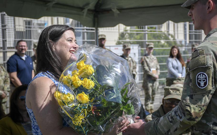 LeeAnn Murray, wife of Brig. Gen. Clinton Murray, accepts flowers at a change of command ceremony in Landstuhl, Germany, June 1, 2022.