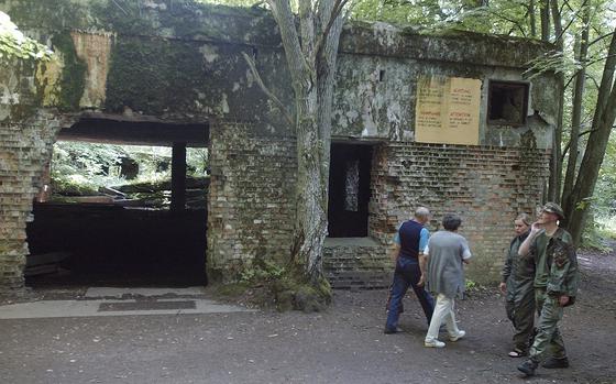 FILE - Tourists visit the ruins of Adolf Hitler's headquarters the "Wolf's Lair" in Gierloz, northeastern Poland, July 17, 2004 where his chief of staff members made an unsuccessful attempt at Hitler's life on July 20, 1944. Polish prosecutors have discontinued an investigation into human skeletons found at Wolf's Lair where German dictator Adolf Hitler and other Nazi leaders spent time during World War II because the advanced state of decay made it impossible to determine the cause of death, a spokesman said Monday, May 6, 2024.  (AP Photo/Czarek Sokolowski, File)