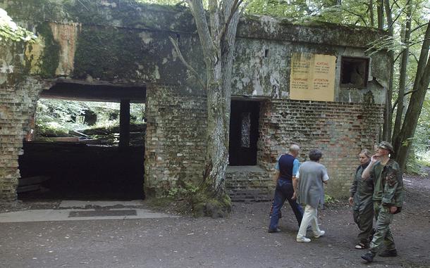 FILE - Tourists visit the ruins of Adolf Hitler's headquarters the "Wolf's Lair" in Gierloz, northeastern Poland, July 17, 2004 where his chief of staff members made an unsuccessful attempt at Hitler's life on July 20, 1944. Polish prosecutors have discontinued an investigation into human skeletons found at Wolf's Lair where German dictator Adolf Hitler and other Nazi leaders spent time during World War II because the advanced state of decay made it impossible to determine the cause of death, a spokesman said Monday, May 6, 2024.  (AP Photo/Czarek Sokolowski, File)