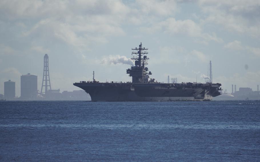The aircraft carrier USS Ronald Reagan steams through Tokyo Bay on its way to Yokosuka Naval Base, Japan, Friday, Aug. 25, 2023. 
