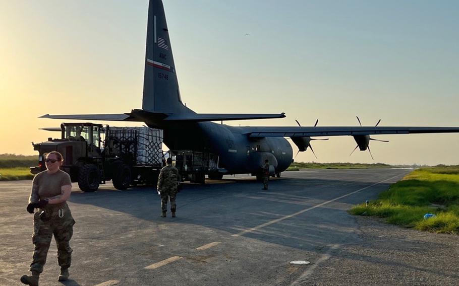 Airmen from the 387th Air Expeditionary Squadron quick reaction team offload humanitarian supplies from a C-130 cargo plane at Begum Nusrat Bhutto Airport Sukkur, Pakistan, Sep. 9, 2022. 