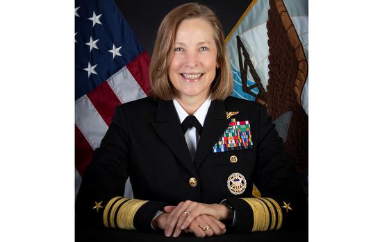 A female sailor smiles for a portrait