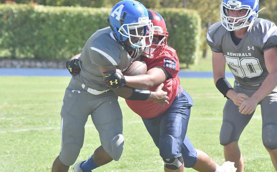 Rota's Kiviti Golfried originally had the ball on this play, but Aviano's Paul Ablang jarred it loose - one of several early fumbles the Admirals had in a 42-0 loss to the Saints on Saturday, Sept. 10, 2022.