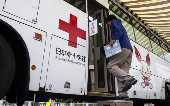 Base worker Hiroyuki Shigeyama boards a bus to donate blood to the Japanese Red Cross at Marine Corps Air Station Iwakuni, Japan, April 11, 2024.