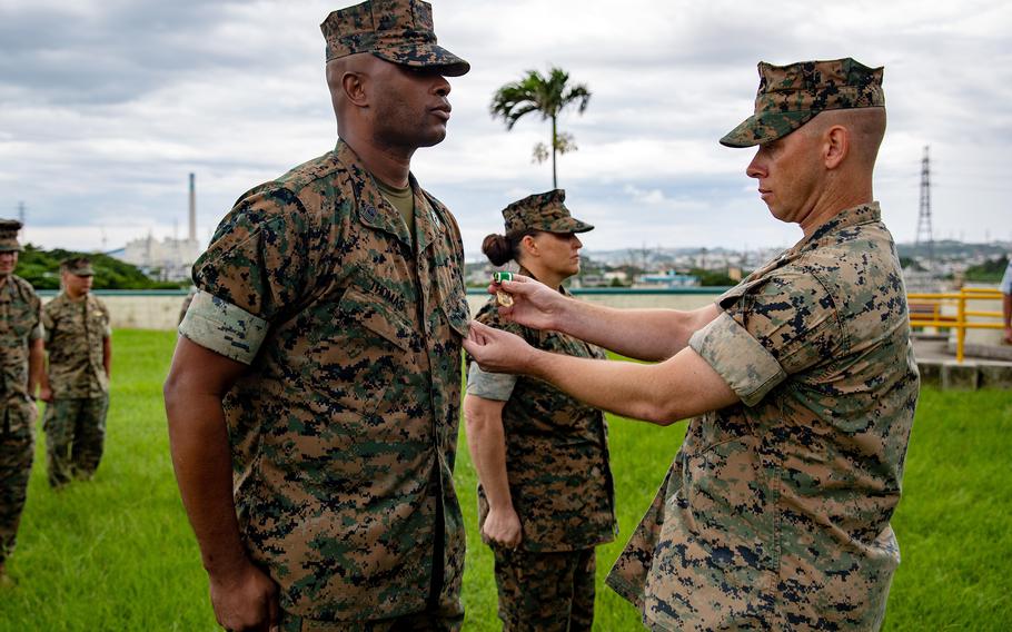 Master Gunnery Sgt. Ronald Thomas and his wife, Master Sgt. Sara Thomas, receive the Navy and Marine Corps Commendation Medal at Camp Courtney, Okinawa, June 15, 2021. The pair was honored for heroic actions during a flash flood last year at Ta-Taki Falls.