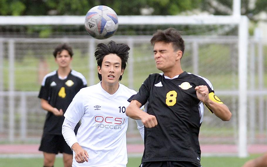 Kadena’s Tuck Renquist heads the ball against Okinawa Christian’s Seiya Ohkawara during Wednesday’s Okinawa boys soccer match. The Panthers won 10-1.